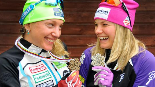 Caitlin Gregg and Jessie Diggins smile at their World Championships medals. [P]USSA