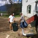 Chase helps bring demolished bits of house up from the basement. [P] Middlebury Ski Team