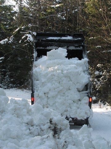 Trucking snow out to the trails...