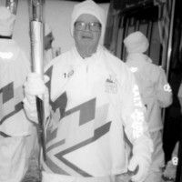 Vern carries the torch for the 2002 Winter Olympic Games that were held in Salt Lake City, Utah. [P] courtesy of Joe Lamb