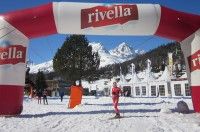 Caitlin standing under the Rivella blimp on the Engadin race course [P] Holly Brooks