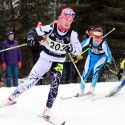 Cendrine Browne (bib 203) skis ahead of Sophie Carrier-Laforte (bib 209) as another competitor takes a spill. [P] John Sims