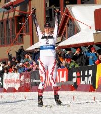 Chandra Crawford celebrates victory at the finish line in her hometown of Canmore. [P] Pam Doyle