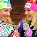 Caitlin Gregg and Jessie Diggins smile at their World Championships medals. [P]USSA