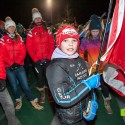 A young racer carries the flag for the Canadian squad at the Canmore Biathlon opening ceremonies [P] Pam Doyle